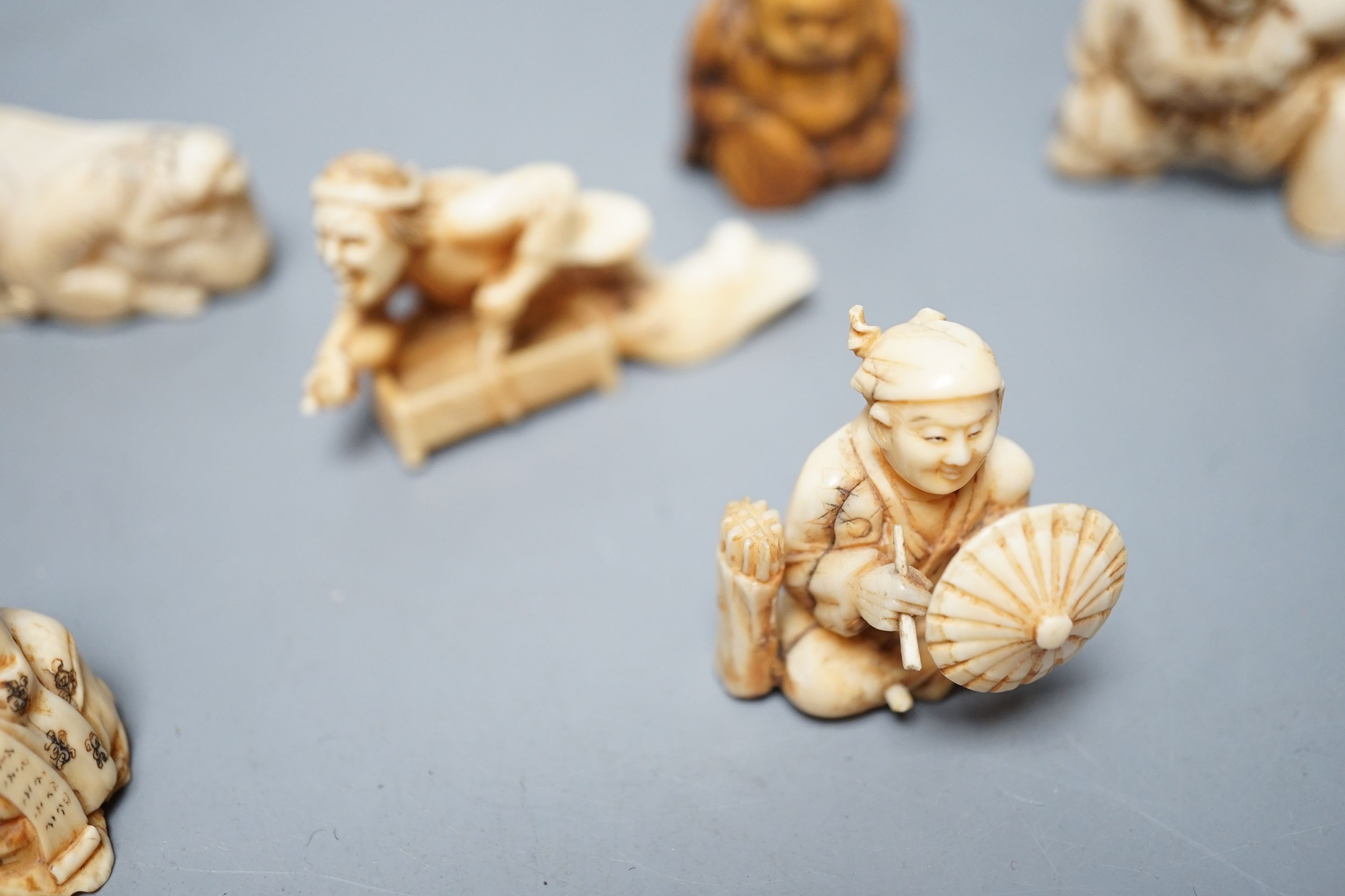A collection of eight Japanese Ivory and bone Netsuke and okimono, 19th/early 20th century